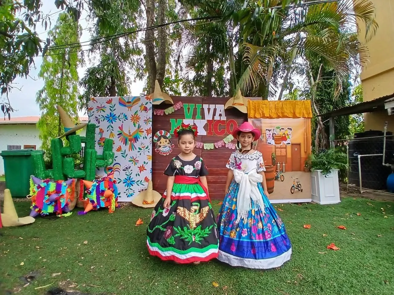 Alumnas con vestidos típicos mexicanos en el stand de México