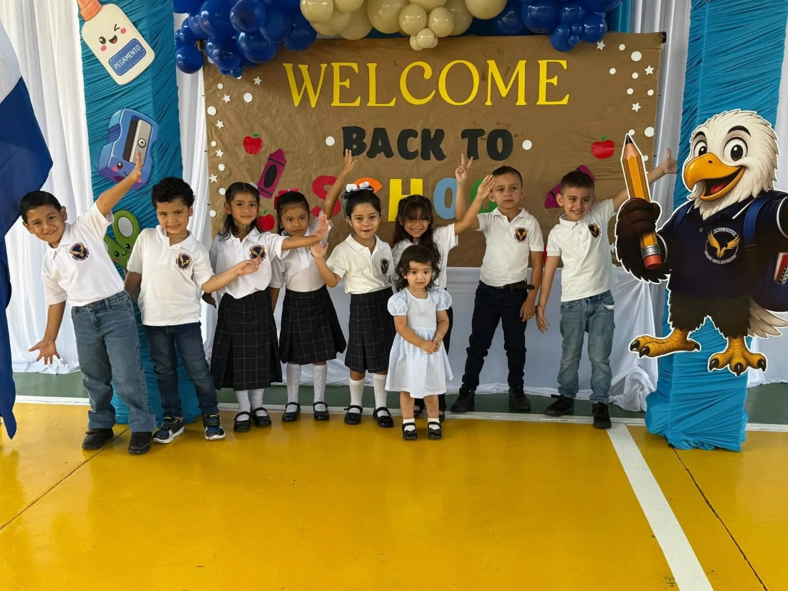 Alumnos de Eagles Academy junto a la mascota del águila en la bienvenida del año escolar